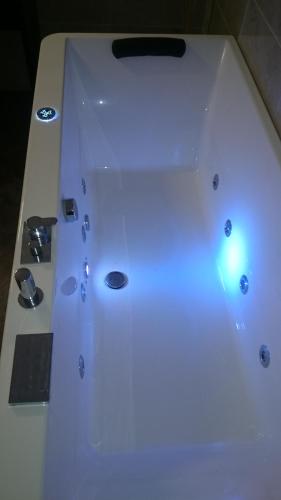 a white bathtub with a light on top of it at Affittacamere Villa Giulia in Moneglia