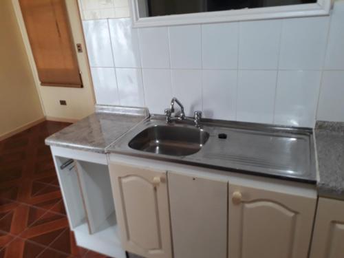 a kitchen with a sink and a counter at Casa Jardines del Mar, Puerto Montt in Puerto Montt
