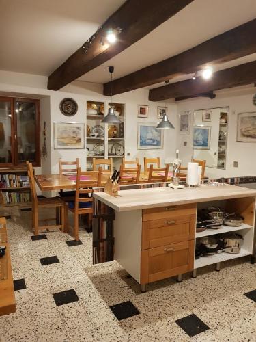 a kitchen and dining room with a table and chairs at Le Vieux Couvent in Deviat