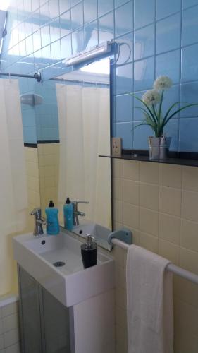 a bathroom with a sink and a mirror at F! Lisbon Guest House in Lisbon