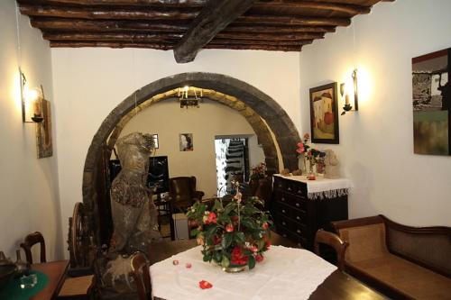 a room with a table with a vase of flowers on it at Ponta Delgada - Casa Rural in Ponta Delgada