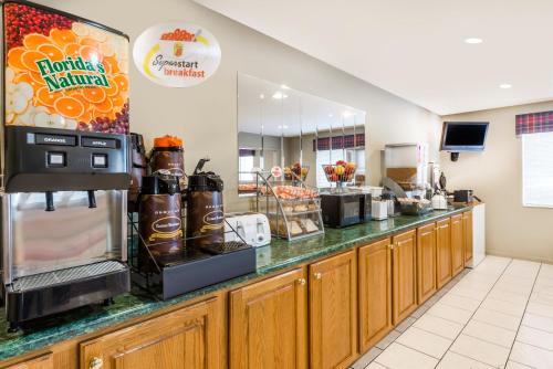 a fast food restaurant with a counter with a coffee shop at Super 8 by Wyndham Chanute in Chanute