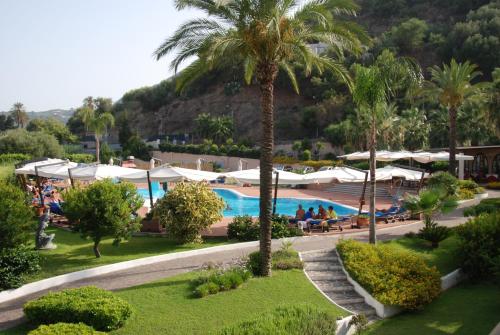 a view of a resort with a pool and palm trees at Hotel Aktea in Lipari