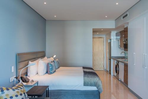 a hotel room with a bed and a table at The Capital Pearls Hotel in Durban