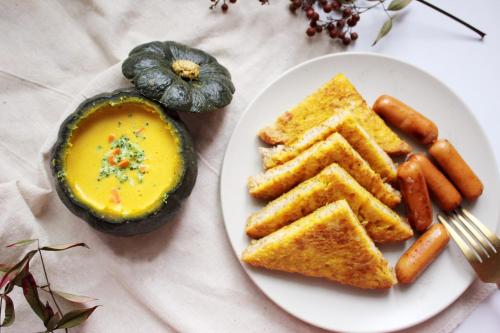 a plate of food with toast and carrots and a dip at Shell Villa apartel resort in Koror