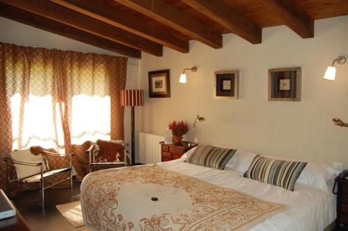 a bedroom with a large bed in a room at Molino De La Ferrería in Villacorta