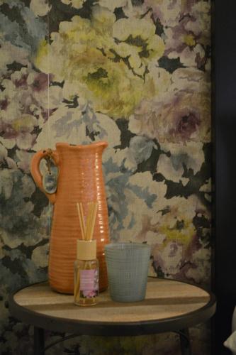 an orange vase sitting on a table with a wall at Suite 17 in Eindhoven