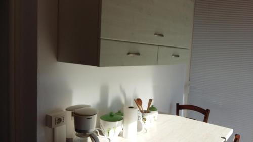 a kitchen with a table with a hair dryer on it at Casa delle Camelie in Sorico