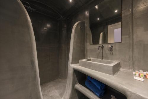 a bathroom with a sink and a mirror at Blue Waves Suites & Apartments in Kamari