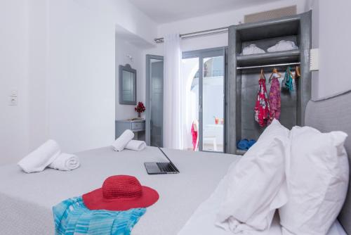 a red hat sitting on top of a bed at Blue Waves Suites & Apartments in Kamari