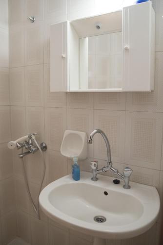 a bathroom with a sink and a shower head at Psiloritis in Kalamaki Heraklion