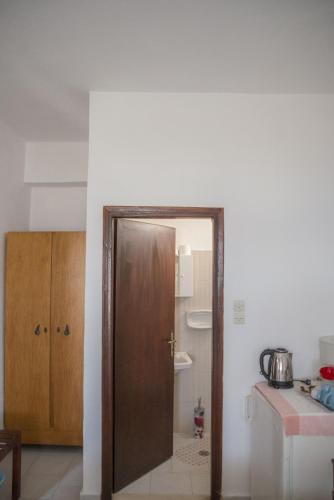 an open door in a kitchen with a sink at Psiloritis in Kalamaki Heraklion
