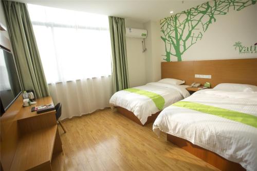 a hotel room with two beds and a window at Vatica Hefei Yaohai District Linquan Road Anhui Big Market Hotel in Hefei