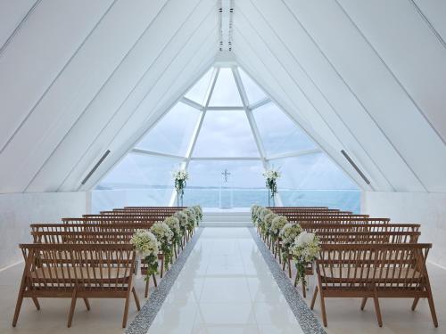 a row of chairs in a room with a large window at Sheraton Okinawa Sunmarina Resort in Onna