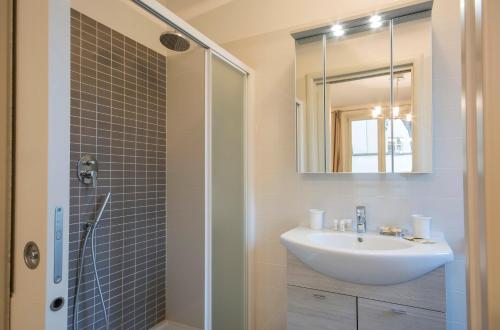 a bathroom with a sink and a shower with a mirror at Borgo Guelfo III in Florence