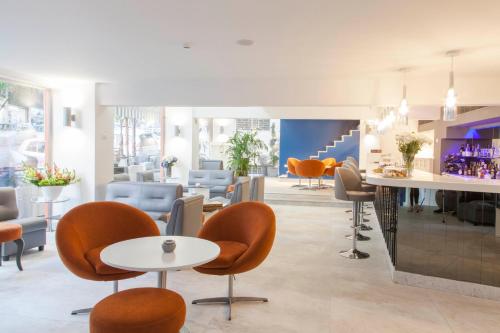 a waiting room with chairs and tables and a counter at Aleph Boutique Hotel in Jbeil