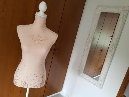 a mannequin in a display case next to a mirror at Hotel Villa Verde in Düsseldorf