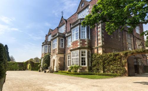 an exterior view of a large house with a driveway at Goldsborough Hall in Knaresborough