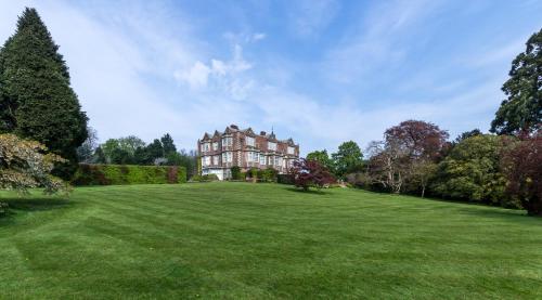 a large house on a large grassy field at Goldsborough Hall in Knaresborough