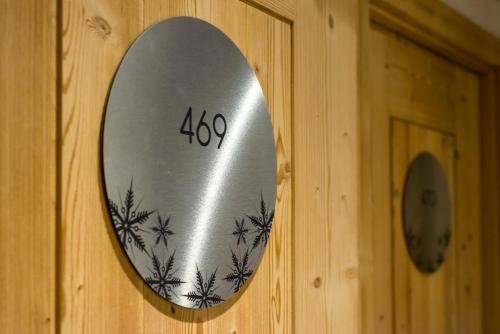 a mirror on a wooden door with at Hotel Eterlou in Méribel