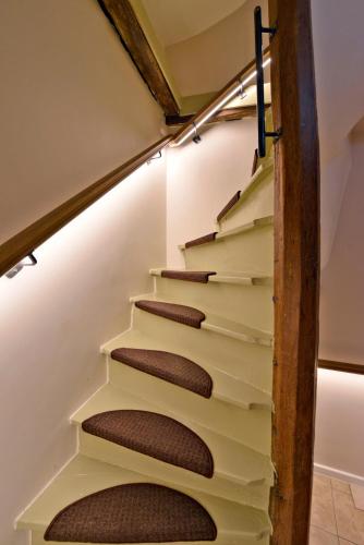 a stairwell in a house withbrown treads at Rooms With A View in Ghent