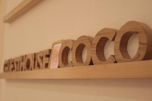 a wooden shelf with the word oak written on it at Guesthouse COCO Hiroshima (Female Only) in Hiroshima