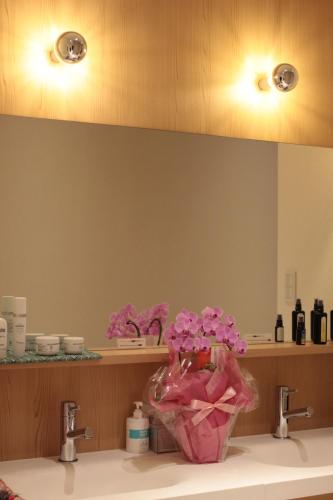 a bathroom with a sink with pink flowers on it at Guesthouse COCO Hiroshima (Female Only) in Hiroshima