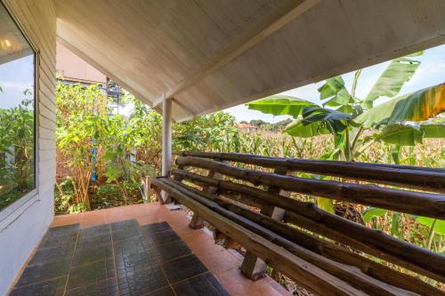 a wooden bench sitting on a porch at Rosemary House in Pak Chong