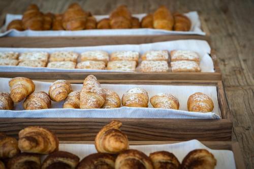 a display of different types of pastries in trays at Gabbiano Azzurro Hotel & Suites in Golfo Aranci