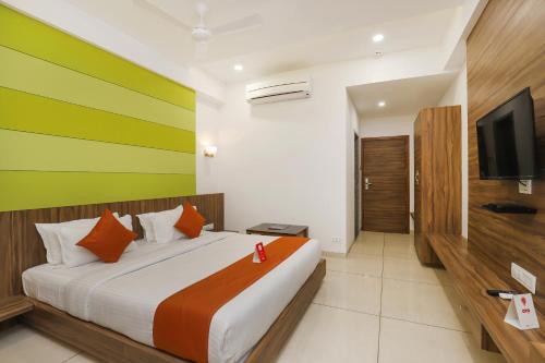 a bedroom with a large bed with a colorful wall at Hotel Avista in Vadodara