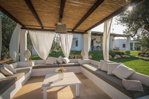 a living room with white couches and a table at Villa del Vento in Polignano a Mare