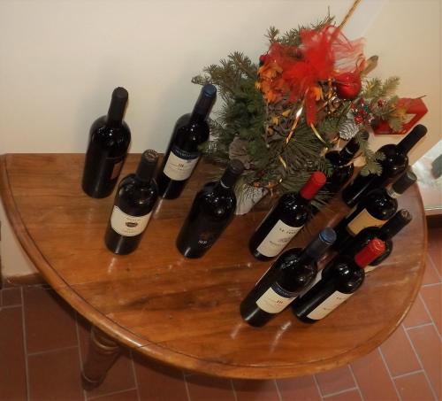 a group of wine bottles on a table at Tenuta Villa Colle Sereno in Montemarciano