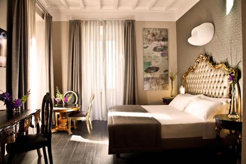 Ein Bett oder Betten in einem Zimmer der Unterkunft Hotel Valadier