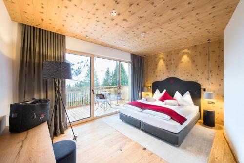 A bed or beds in a room at Adler Damüls Gasthof Hotel