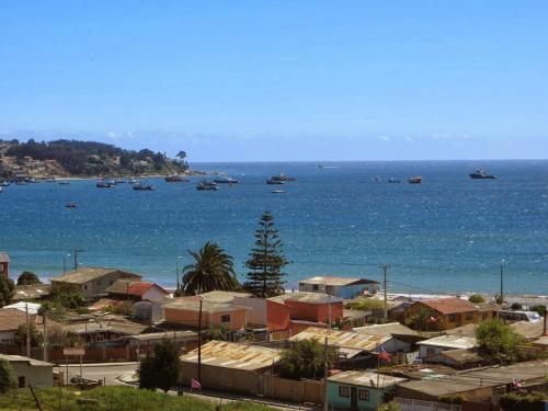 a group of boats in the water near a city at Casa Jade in Quintero