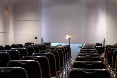 an empty conference room with chairs and a table at Hotel Flora in Frascati