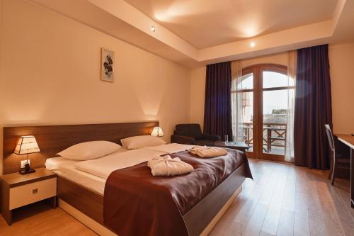 Postel nebo postele na pokoji v ubytování Hotel Gino Wellness Rabath