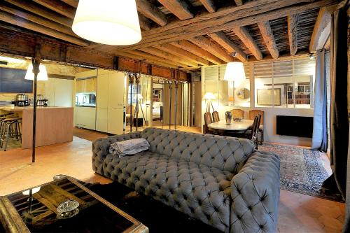 un salon avec un canapé et une table dans l'établissement Beautiful apartment in historical Marais, à Paris