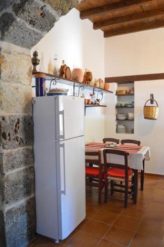 a kitchen with a white refrigerator and a table at Epavlis Iosif in Khóra Sfakíon