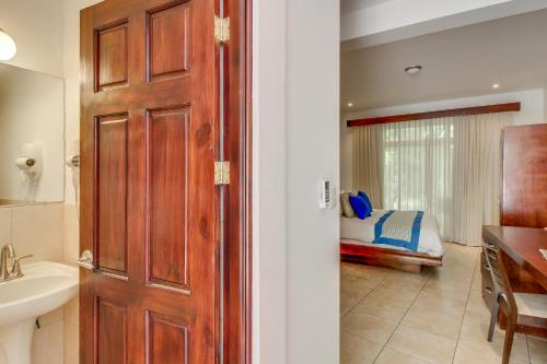 a bathroom with a door leading to a bedroom at Ocotal Beach Club Hotel 2 in Guanacaste