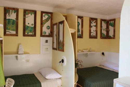 two beds in a small room with at Country House Il Covo della Civetta in Barberino di Val dʼElsa