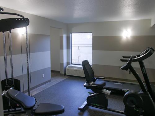 a gym with two treadmills and two exercise bikes at Wingate by Wyndham Louisville Airport Expo Center in Louisville