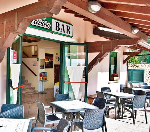a restaurant with tables and chairs on a patio at Residence Bellavista in Manerba del Garda