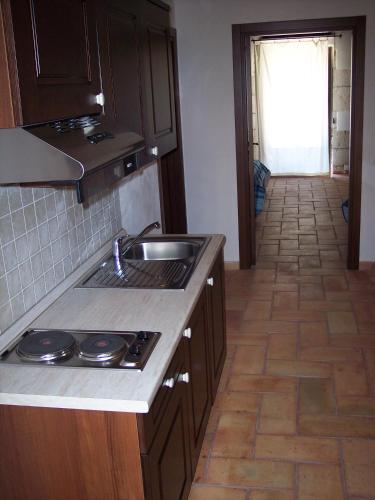 a kitchen with a sink and a counter top at Case di Cutalia - Villa Cutalia in Camemi