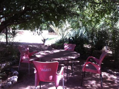a table and chairs sitting under a tree at Villa Morabeza Guest House in Mindelo