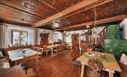 a dining room with tables and chairs in a building at Zum Kirchenbauer in Oberammergau