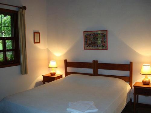 Un pat sau paturi într-o cameră la Pousada do Capão