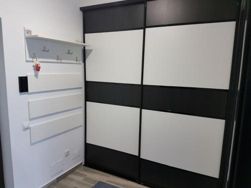 a closet with white drawers and a black wall at Russo in Chişinău