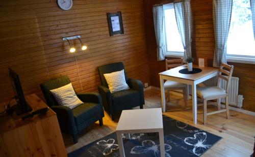 a living room with two chairs and a table at Doro Camp Lapland in Dorotea