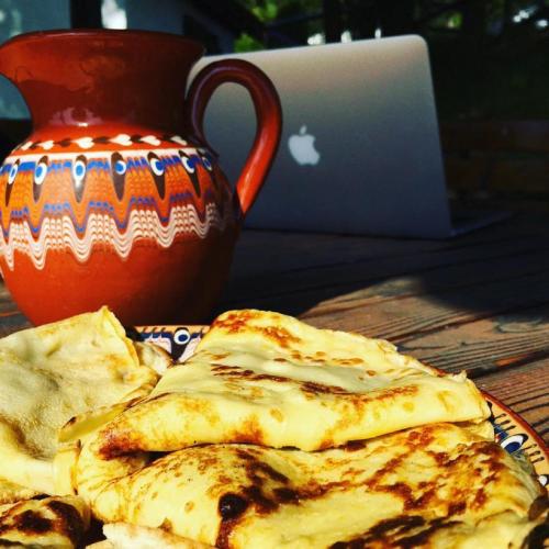 a plate of food on a table with a laptop at Villa Mark in Kraevo
